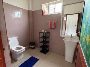 a bathroom with a toilet and a sink at Coral Reef Guest in Beruwala +21 photos