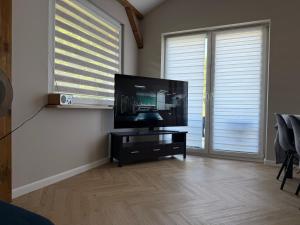a living room with a flat screen tv on a table at Chill and Grill Apartments in Wola Smolana +9 photos