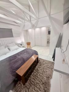 a bedroom with a large bed and a rug at The White House - Zonnebloem in Cape Town +53 photos
