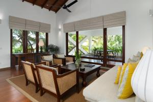a living room with a couch and a table at Aavya Cove Villas by Aahaasa in Balapitiya