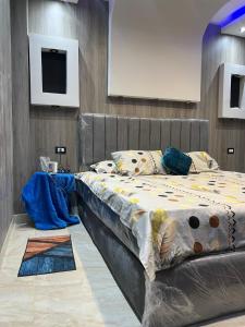 a large bed in a room with a television at Mazen Zakaria apartment in Port Said