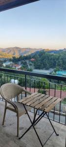 a wooden bench sitting on top of a balcony at PetroLithos Traditional Suites in Agros