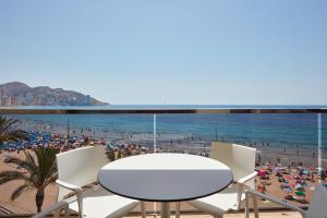 a table and chairs on a beach with a view at Don Cesar Boutique Apartments in Benidorm +18 photos