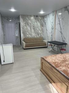 a room with a couch and a table in it at Blue Horizon in Grigoleti