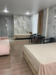a hotel room with two beds and a table at Blue Horizon in Grigoleti +2 photos
