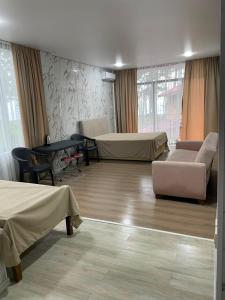 a hospital room with two beds and a table at Blue Horizon in Grigoleti