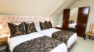 a hotel room with two beds and a mirror at Bellinter House Hotel & Spa in Navan