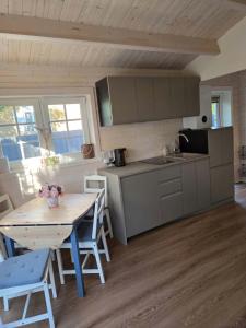a kitchen with a wooden table and a table and chairs at AMONG Nature Stay in Vilnius in Vilnius