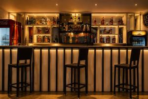 a bar with two bar stools in a room at Roy's Polonnaruwa in Polonnaruwa