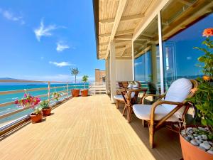 a balcony with chairs and a view of the ocean at EKA Luxury Beachfront Apartments in Vlorë