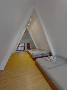 two beds in a room with a attic at Balay @ Santa Fe, Bantayan in Pooc