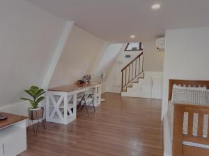 a living room with a table and a staircase at Balay @ Santa Fe, Bantayan in Pooc