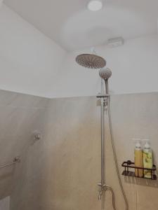 a shower with a shower head in a bathroom at Balay @ Santa Fe, Bantayan in Pooc +9 photos