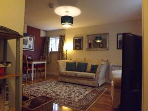 a living room with a couch and a table at Small cosy bothy in Dingwall