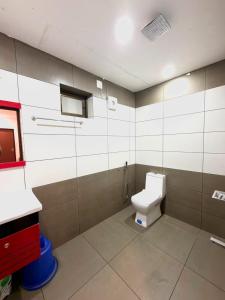 a bathroom with a toilet and a sink at Wayanad Way Resort in Koroth