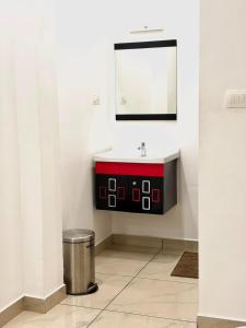 a bathroom with a red sink and a mirror at Wayanad Way Resort in Koroth