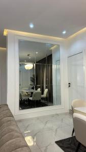 a living room with a table and chairs and a mirror at Flat in lekki2 bed apartment in Lekki