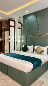 a bedroom with a large bed with a green wall at Flat in lekki2 bed apartment in Lekki