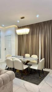 a dining room with a table and white chairs at Flat in lekki2 bed apartment in Lekki