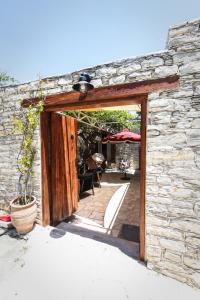 an open door to a stone building with a patio at Arhontiko Frangos in Kato Drys