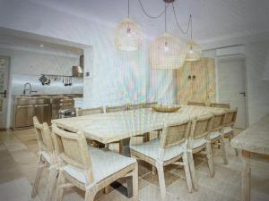 a dining room with a table and chairs at Villa Sunset Bay in Baja Sardinia