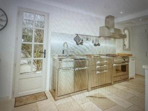 a kitchen with a sink and a stove at Villa Sunset Bay in Baja Sardinia +7 photos
