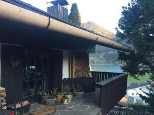 a balcony of a house with a view of a lake at Villa overlooking Lake Thiersee in Vorderthiersee +7 photos