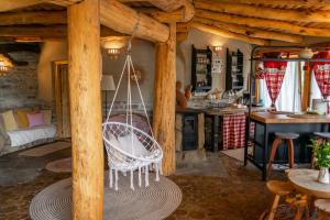 a swinging chair in a room with a kitchen at Casa cu Suflet in Sighişoara