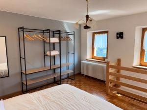 a bedroom with a bed and a book shelf at Appartamento Girasole - Cadore Apartments in Candide