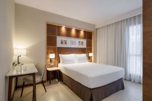a hotel room with a bed and a desk and a bed at Dorma León in León +57 photos