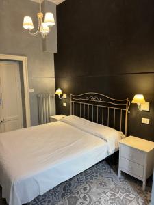 a bedroom with a large bed and two tables at Boutique Hotel Washington Milano - JCUBE HOTELLERIE in Milan