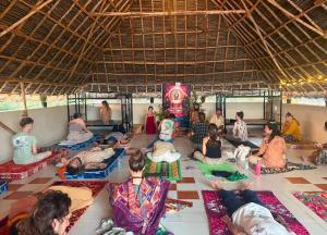 a group of people sitting on the floor in a room at Thilo Guest House Auroville in Auroville +64 photos