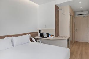 a hotel room with a bed and a desk at B&B HOTEL Murcia Thader in Churra +7 photos
