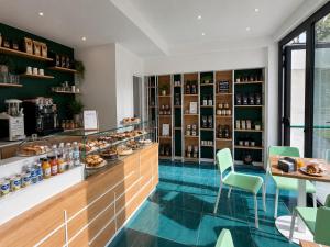 a bakery with a counter and chairs in a room at The Queen Oak - nature relais in Santa Marina