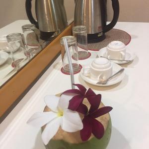 a vase with a flower in it on a table at South Ari Inn in Mandhoo