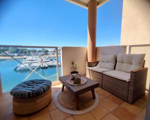 a living room with a couch and a table at La Terrasse des Voiliers in Frontignan
