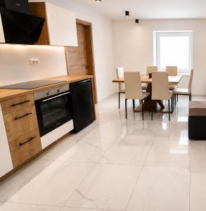 a kitchen and dining room with a table and chairs at Apartma 47 in Kobarid