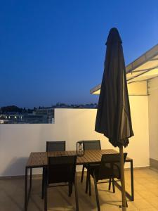 a patio with a table and an umbrella at Downtown View Apartment - Rhodes in Rhodes Town +5 photos