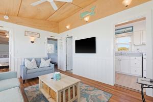 a living room with a couch and a tv at Beach Home With Beautiful Ocean Views in Dennis