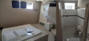 a bathroom with a shower and a sink and a toilet at Motel Classe A in Limeira +2 photos