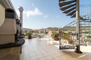a balcony with tables and chairs on a building at Residence Le Fontane in Villasimius