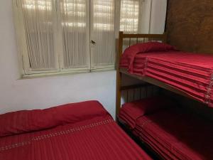 a room with two bunk beds and a window at Complejo el cordobes in Albardón