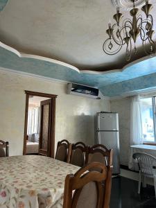a room with a table and chairs and a refrigerator at Beka's GuestHouse in Gonio