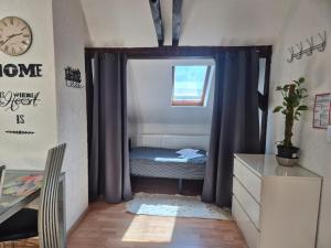 a small bedroom with a bed in a window at Revant West 3 in Arnstadt