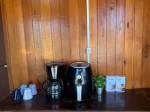 a counter with a coffee maker and a blender at CABANAS BELVEDERE SERRA DO RiO DO RASTRO in Lauro Müller +13 photos