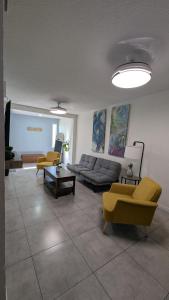 a living room with a couch and two chairs at Acogedora Casa in El Sauzal