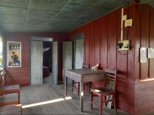 a dining room with a table and chairs at Nature Dormitory in Ban Donsôm Tai