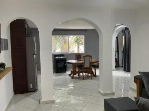 a kitchen and dining room with a table and chairs at HUMMINGBIRD Hotel Cabarete in Cabarete