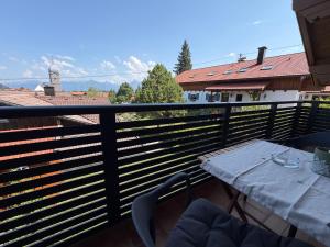 a table and chairs on a balcony with a view at Ferienwohnen beim Hirsch in Hopferau