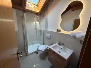 a bathroom with a sink and a shower and a mirror at Ferienwohnen beim Hirsch in Hopferau +37 photos
